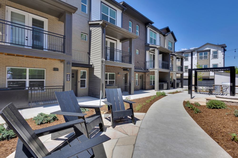 Adirondack chairs on the courtyard of The Allyson Townhomes